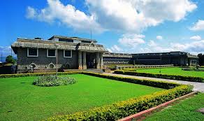 Exterior view of Nagarjunakonda Museum featuring ancient Buddhist relics, well-maintained green lawns